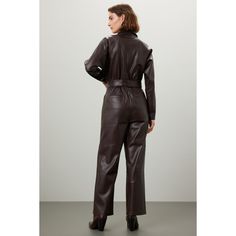 Brown faux leather (100% Polyurethane). Jumpsuit. Long sleeves. Collar. Front button closure. 26.5" from shoulder to hemline. 14" rise. 19" leg opening. Imported. Fall Workwear Jumpsuits And Rompers With Belt Loops, Sleek Workwear Jumpsuits And Rompers For Fall, Sleek Fall Workwear Jumpsuits And Rompers, Chic Fall Office Jumpsuits And Rompers, Chic Office Jumpsuits And Rompers For Fall, Chic Fall Jumpsuits And Rompers For Office, Sleek Jumpsuits And Rompers For Fall Workwear, Chic Office Jumpsuits For Fall, Solid Belted Jumpsuits And Rompers For Fall