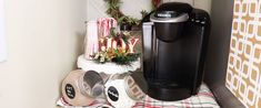 a coffee maker sitting on top of a counter next to christmas decorations and candy canes