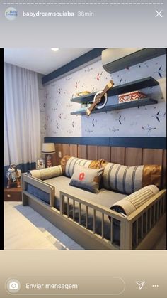 a living room with a couch and some shelves on the wall above it that are decorated in blue and white