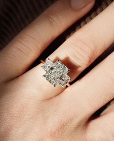 a woman's hand with a diamond ring on it