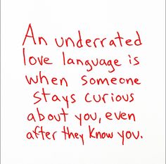 a handwritten poem written in red ink on white paper that reads an underrated love language is when someone stays curious about you, even after they know you