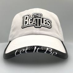 "Here Comes the Sun This collection of Classic unstructured low profile hats have the iconic Beatles logo.  One Size Fits Most Hats come in several different colors. The BrimmTrimm variations are ready for optional customization! BRIMMTRIMM'S come in Black, Red, Gray,White and Pink. Please message if you would like a different Hat/BRIMMTRIMM color option. We would be taking pictures for a week to list them all Customers have requested song titles like \"Here Comes the Sun\" or an album such as Rubber Soul or even the names of the Fab Four \"John Paul George Ringo\" to customize their BRIMMTRIMM'S! There are  endless customization options! OSFM (6 5/8-7 3/8) Hat and OSFM BRIMMTRIMM.  Adjustable Buckle Closure. BRIMMTRIMM can also be removed to wear on any other hat.  So if you have other Be Black Hat With Logo Print And Flat Brim, Adjustable Visor Hat With Logo, Adjustable Flat Brim Baseball Cap With Logo Print, Adjustable Baseball Cap With Logo Print, Fan Merchandise Baseball Cap With Curved Brim, Curved Brim Dad Hat Fan Merchandise, Retro Adjustable Baseball Cap For Fans, Adjustable Flat Brim Baseball Cap With Logo, Adjustable Dad Hat With Curved Brim For Fans