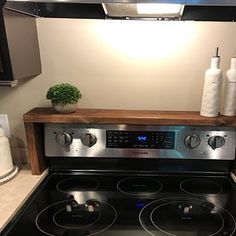 a stove with two burners in a kitchen next to a counter top and an oven hood