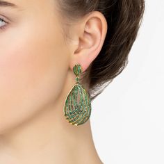 Get ready to be mesmerized by our Vortex Teardrop Earrings in Green Gold. These earrings are pure magic. The 3D teardrop shape showcases an open lattice design, peppered with twinkling zircons that'll have you captivated. Adding to the hypnotic allure, each earring has a smaller teardrop shaped studded top, also glammed up with zircons. This design lets the earring sway naturally, capturing the light—and all the attention. Handcrafted in 925 Sterling Silver dipped in 18ct gold. Cubic Zirconia. Luxury Green Teardrop Earrings, Luxury Teardrop Earrings For Party, Elegant Green Teardrop Pendant Earrings, Lattice Design, Earrings Green, Independent Designers Fashion, Green Gold, Teardrop Earrings, Jewelry Branding