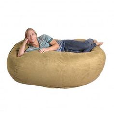 a woman laying on top of a large bean bag chair