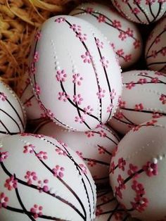 some white eggs with pink flowers painted on them