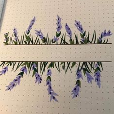 some purple flowers are on the side of a white board