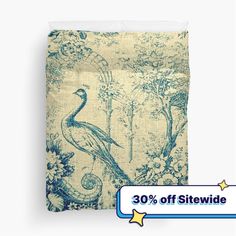 a blue and white pillow with an image of a bird in the woods on it