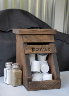 a wooden box with coffee cups in it