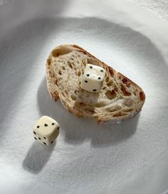 two dice are sitting on top of a piece of bread