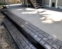 a concrete patio with steps leading up to it