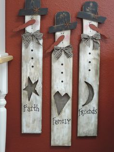 three wooden wall hangings with hats and stars on them, one has the word faith written