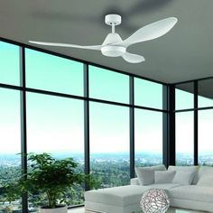 a modern living room with large windows and a ceiling fan in the middle of it