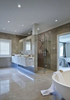 a large bathroom with marble floors and walls