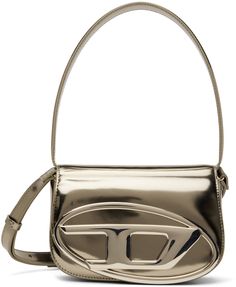 Structured patent leather top handle bag in metallic beige. · Fixed carry handle · Detachable and adjustable shoulder strap · Logo hardware at face · Concealed patch pockets at face · Foldover flap with magnetic press-stud closure · Patch pocket at interior · Twill lining in black · H5 x W8 x D2.25 in Supplier color: Bronze 1dr Bag, Diesel Clothing, Color Bronze, Virtual Closet, Press Studs, Handle Bag, Leather Top, Luxury Streetwear, Patch Pocket