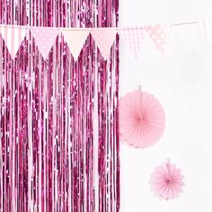 pink party decorations and streamers on a white background