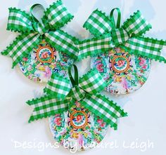 three green and white christmas ornaments with bows