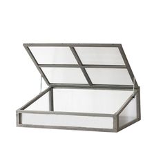 an open glass box sitting on top of a white surface with the lid opened to reveal a window