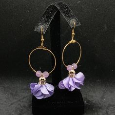 A Pair Of Earrings With A Pale Purple Flower Dangling From Gold Tone Hoops, With Beads Matching The Color On Either Side. Made By Me. Never Worn. Purple Beaded Earrings For Party, Lavender Adjustable Dangle Beaded Earrings, Lavender Beaded Dangle Earrings, Purple Flower Earrings For Party, Elegant Lavender Beaded Drop Earrings, Elegant Purple Flower Earrings For Party, Elegant Lavender Beaded Earrings, Adjustable Purple Flower Earrings As Gift, Adjustable Purple Flower Earrings For Gift