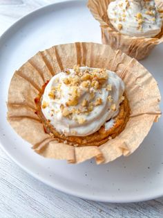 two cupcakes sitting on top of a white plate