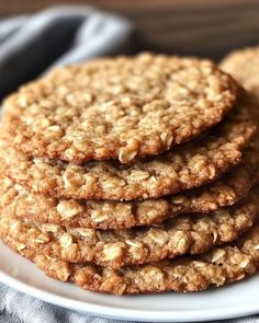 a stack of oatmeal cookies sitting on top of a white plate