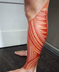 a man's leg with an orange and red tattoo on it