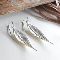 Our wonderful Sterling Silver Dangly Lanceolate Leaf Earrings are perfect for people who love their jewellery to be nature inspired. These fantastic sterling silver earrings capture the intricate detail of a leaf making them a wonderful gift for lovers of the natural world. Effortlessly combining the beauty of nature with the elegance of silver, why not complete the set with the matching necklace. Lanceolate refers to the shape of the leaf which is similar to the head of a lance. All Martha Jackson jewellery comes complete with a gift box and blank gift card fro you to write a short message on Made from Sterling Silver. Keep clean with an anti tarnish cloth. Dimensions 4cm x 1cm. Nickel-free Leaf-shaped Nature-inspired Earrings, Silver Leaf-shaped Minimalist Earrings, Silver Leaf Minimalist Earrings, Sterling Silver Leaf Earrings With Ear Wire, Minimalist Silver Leaf Earrings, Nature-inspired Hypoallergenic Leaf Earrings, Nickel-free Leaf-shaped Sterling Silver Earrings, Minimalist Leaf-shaped Sterling Silver Earrings, Minimalist Sterling Silver Leaf-shaped Earrings