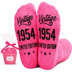 two pink socks with the words vintage written on them next to a bag of tissues