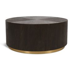 a round wooden table with gold trim around the edge and black wood grain on top