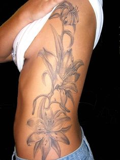 a woman with a tattoo on her stomach has flowers growing out of the side of her body