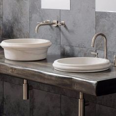 two white sinks sitting next to each other on top of a counter