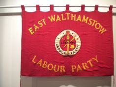 an east wallhamstow labor party banner hanging on the wall in front of a door