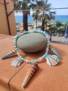 A unique piece of Summer-feeling. Al gem-stones are placed on real shells by hand to create the ultimate summer vibes! Dare to shine! Handmade Strand Jewelry For Beach Party, Handmade Jewelry For Beach Party, Beaded Shell Jewelry For Beach Season, Handmade Turquoise Jewelry For Beach Party, Handmade Jewelry For Beach Party Season, Unique Handmade Shell Jewelry, Bohemian Shell Jewelry For Beach Party, Shell Jewelry For Beach Party, Turquoise Bohemian Jewelry For Beach Party