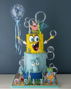 a spongebob themed cake with balloons and decorations