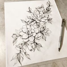 a drawing of flowers on paper with a pen