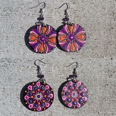 Original hand painted double face mandala earrings. Each pair of earrings is a unique piece, one of a kind. All mandalas are painted by me with original design. The earrings are painted with acrylic colors and finished with water based varnish to keep the colors unaltered and vivid. Other materials: wood, steel, 925 silver ear wire and amethyst stone beads. Earrings total lenght: 7,5 cm Wood pendant diameter: 4 cm You may also like: https://www.etsy.com/shop/AxenArtJewels?ref=seller-platform-mcn Face Mandala, Wire Mandala, Purple Crafts, Mandala Wood, Boho Jewels, Mandala Earrings, Mandala Necklace, Rope Jewelry, Hand Painted Earrings