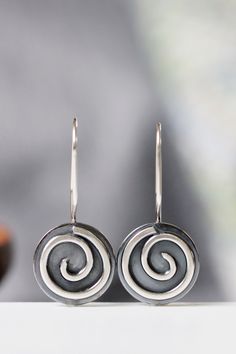 "These earrings are part of my spiral series. They are handcrafted of sterling silver with sturdy 19 gauge ear wires that clip securely in the back. They measure 5/8\" in diameter and about 1 1/8\" in length, and have a bright, shiny finish. I will ship these earrings via USPS First Class Mail within 3-5 days of receipt of payment." Handmade Spiral Sterling Silver Wrap Earrings, Handmade Silver Swirl Earrings, Unique Handmade Spiral Earrings, Unique Spiral Silver Earrings, Nickel Free Silver Swirl Earrings, Unique Spiral Ear Wire Earrings, Unique Silver Spiral Earrings, Sterling Silver Swirl Earrings For Gift, Sterling Silver Spiral Wrap Earring