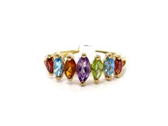 A gorgeous rainbow ring set in 10k yellow gold, made with genuine gemstones of all colors. The gemstones are all prong set.  The center stone, an amethyst, measures 6mm x 3mm, the 4 outer stones measuring 4.25mm x 2.5mm, and the furthest out two gemstones measuring 3.75mm x 2.25mm. The rainbow effect is really lovely and the gemstones all look great together.  Gemstones include amethyst, peridot, garnet, citrine, and blue topaz. This piece is vintage and shows just some light even wear in the wa Multicolor Birthstone Gemstones For Formal Occasions, Multicolor 14k Gold Birthstone Ring With Accent Stones, Multicolor 14k Gold Birthstone Ring As Gift, 14k Gold Multicolor Birthstone Ring With Accent Stones, Multicolor Gemstone Birthstone Ring In 14k Gold, Multicolor 14k Gold Gemstone Birthstone Ring, Formal Multicolor Birthstone Gemstones, Formal Rainbow Gemstone Jewelry, Multicolor Multi-stone Birthstone Ring, Oval Shaped