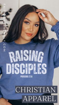 a woman wearing a blue sweatshirt with the words raising disciples on it and an image of her hands behind her head