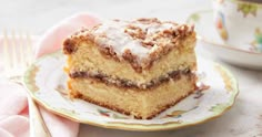 a piece of cake sitting on top of a plate next to a cup and fork