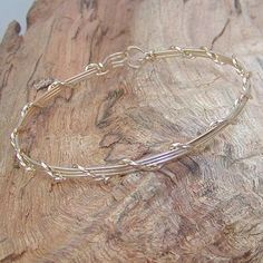 A pretty little bracelet of four strands of 14kt gold filled--three plain square wires, overwrapped with one strand of twist wire. Charming and feminine, and perfect to wear every day. Stackable with so many of my other wirewrapped bracelets! What a sweet graduation gift for a special young lady! Or just as nice for a birthday, Christmas, or Hanukkah. Of course, you can always treat yourself as well! The sturdy built-in hook and eye clasp is easy to get on and off by yourself. Choose your size f Adjustable Gold Sterling Silver Bangle, Gold-plated Nickel-free Sterling Silver Bangle, Gold Sterling Silver Nickel-free Bangle, Delicate Adjustable Wire Wrapped Bracelets, Adjustable Gold Sterling Silver Delicate Bracelet, Teen Jewelry, Wire Bangles, Twisted Wire, Stackable Bracelets