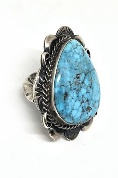 Navajo Artist Betta Lee chose a vivid teardrop shaped Kingman Turquoise stone for this one of a kind ring. Set in a smooth bezel she artistically accented the beauty of the stone with hand stamped Sterling silver sun rays, repousee and rope work. The piece has an antique satin finish for a vintage look. The color and characteristic veining of Arizona Kingman turquoise was sought after by ancient Native Americans and is still appreciated today for its great beauty. This piece is a worthy addition Santa Fe Jewelry, Bold Women, Jewelry Antique, Kingman Turquoise, Sun Rays, American Jewelry, Native American Jewelry, Turquoise Jewelry, Turquoise Stone