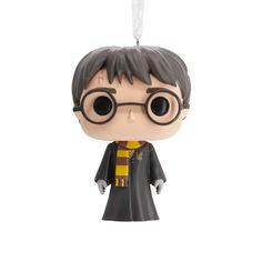 the harry potter ornament is hanging from a string on a white background,