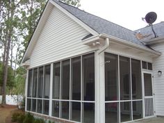 a white house with lots of windows on the roof