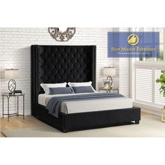 a bed with black headboard and foot board in a white brick wall bedroom area