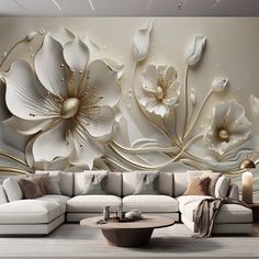 the living room is decorated with white flowers and gold accents on the wall, along with a large sectional sofa