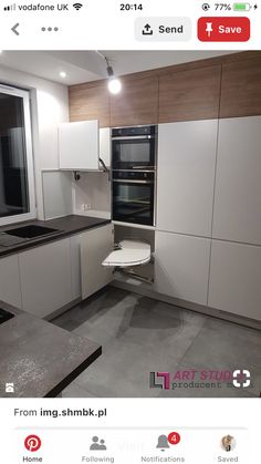 an image of a kitchen setting with white cabinets and black counter tops on instagram