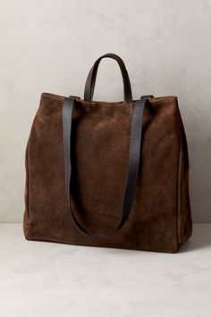 Luxury meets utility in the sophisticated Sutton tote, crafted from genuine waterproof Italian suede leather. Featuring a roomy main compartment that can hold a 13-15" laptop, this rich calfskin suede bag also has a smaller zip compartment and open pocket inside. Carry it with the leather handles or by the shoulder straps—either way, the Sutton takes you where you need to go with all your essentials in tow. With magnetic snap closure, snaps along throat sides, and cotton lining throughout. Fox Fur Boots, Fluffy Boots, Suede Tote Bag, Large Leather Tote Bag, Suede Tote, Leather Bag Women, Fur Boots, Large Tote Bag, Large Tote