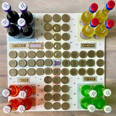 a board game with coins and drinks on it