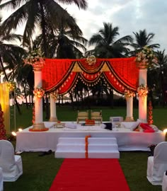 an outdoor wedding setup with red and white decor